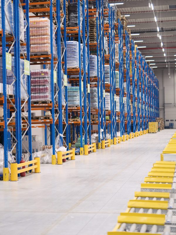 Warehouse storage interior with shelves loaded with goods.